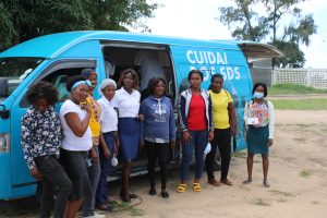 Group of women in front of the mobile optics van. Group of women in front of the mobile optics van.